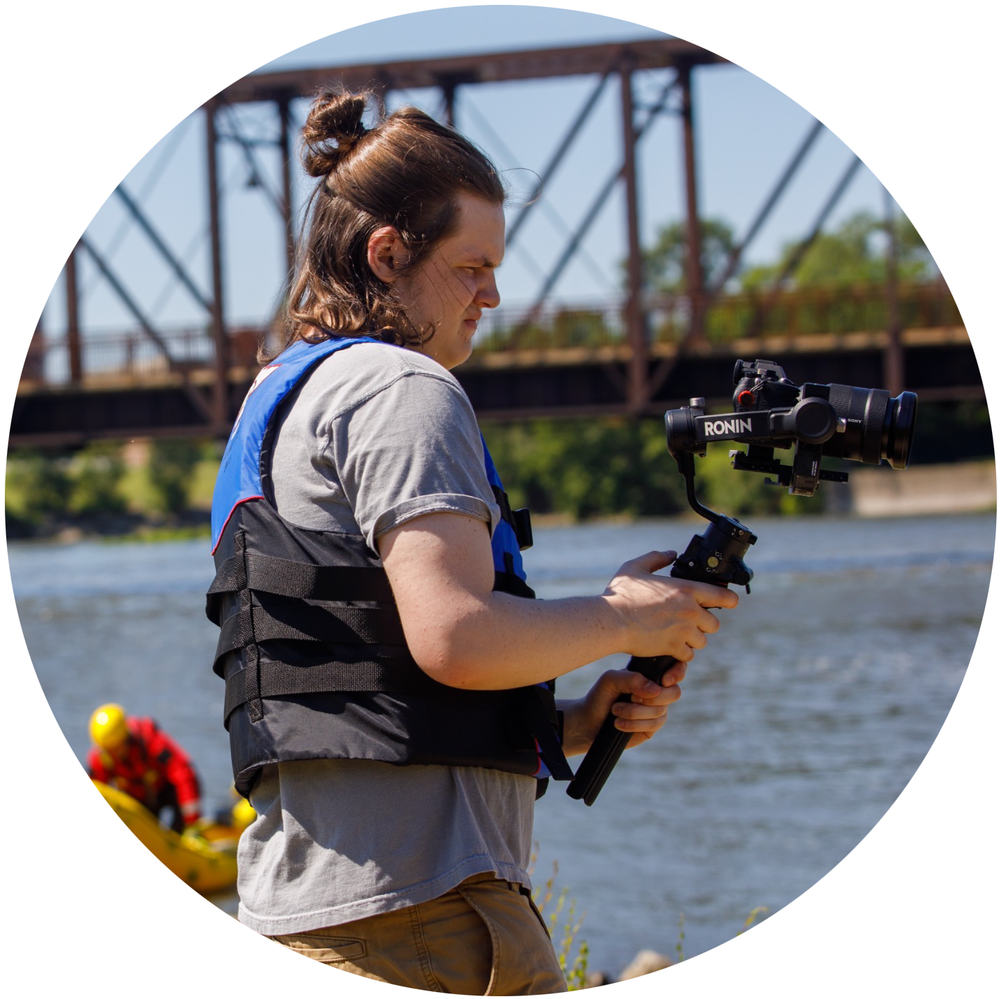 man holding camera on gimbal near River